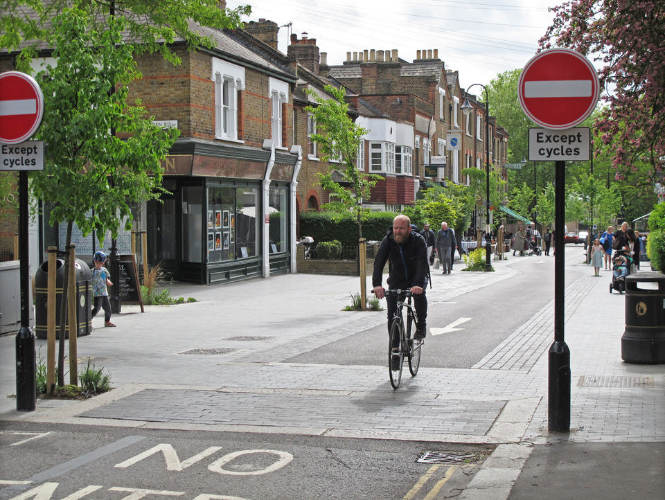 Man rides bike down cycle-only street